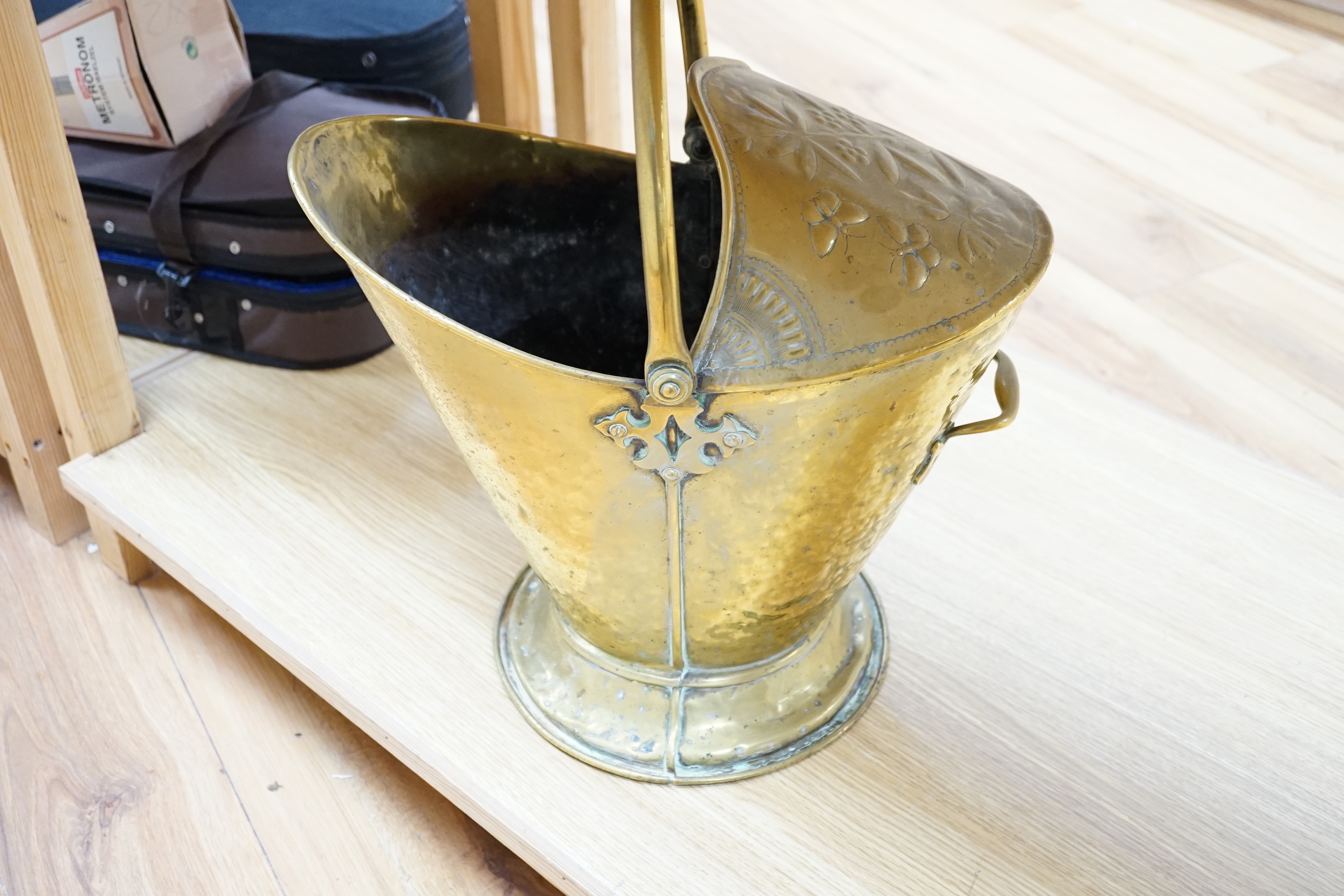 A brass helmet coal scuttle and another